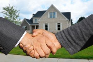 An image of two people shaking hands as an agreement